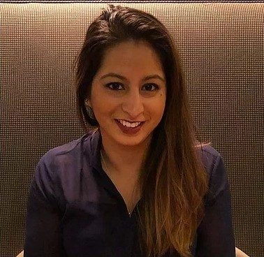 Angela Dahiya-Singh smiling up at camera