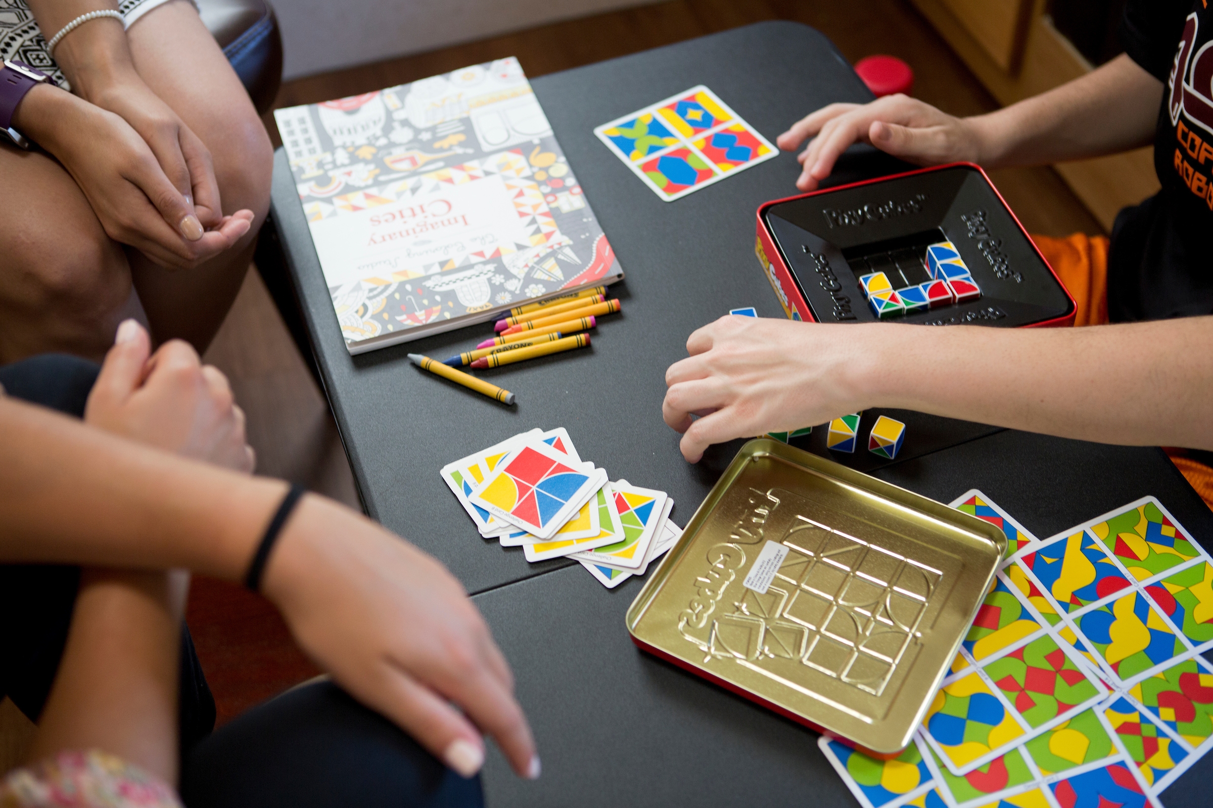 3 sets of hands playing games