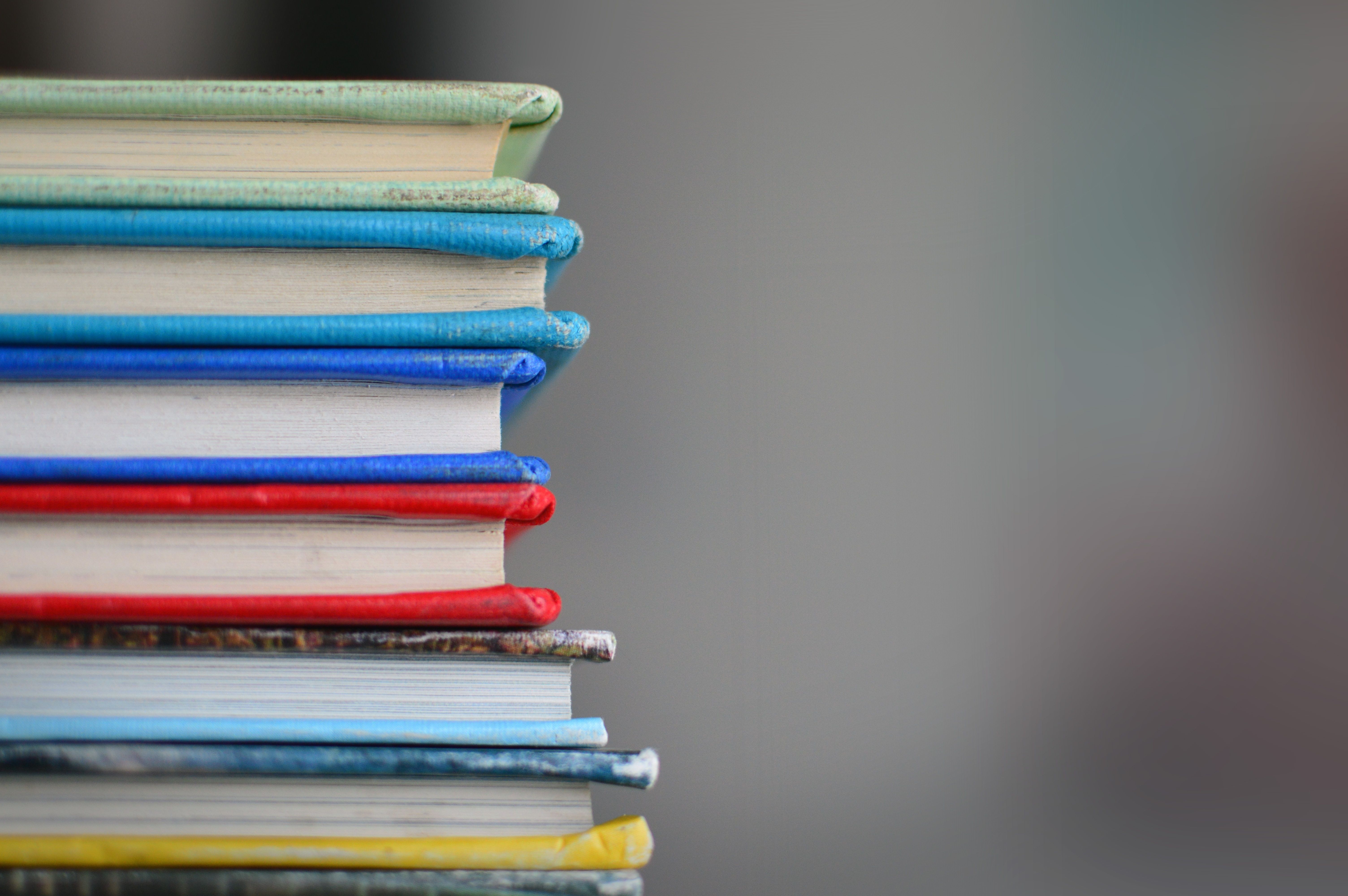 Stack of six colorful, leather bound books